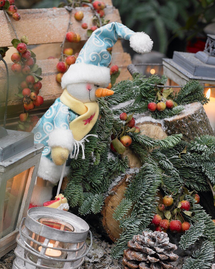 Christmas arrangement with whimsical snowman and fir branches