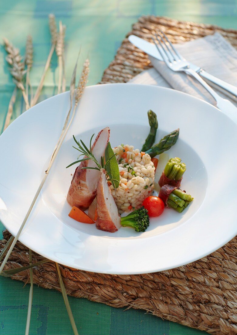 Rabbit fillet wrapped in ham and barley risotto