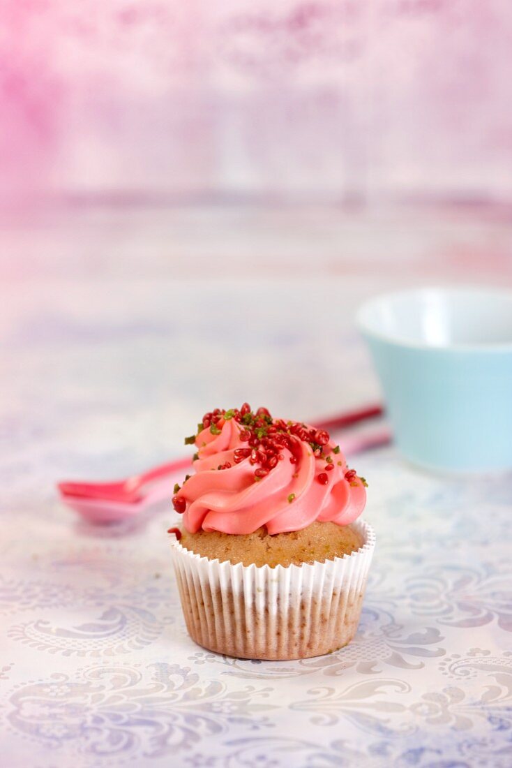 A cupcake topped with strawberry cream