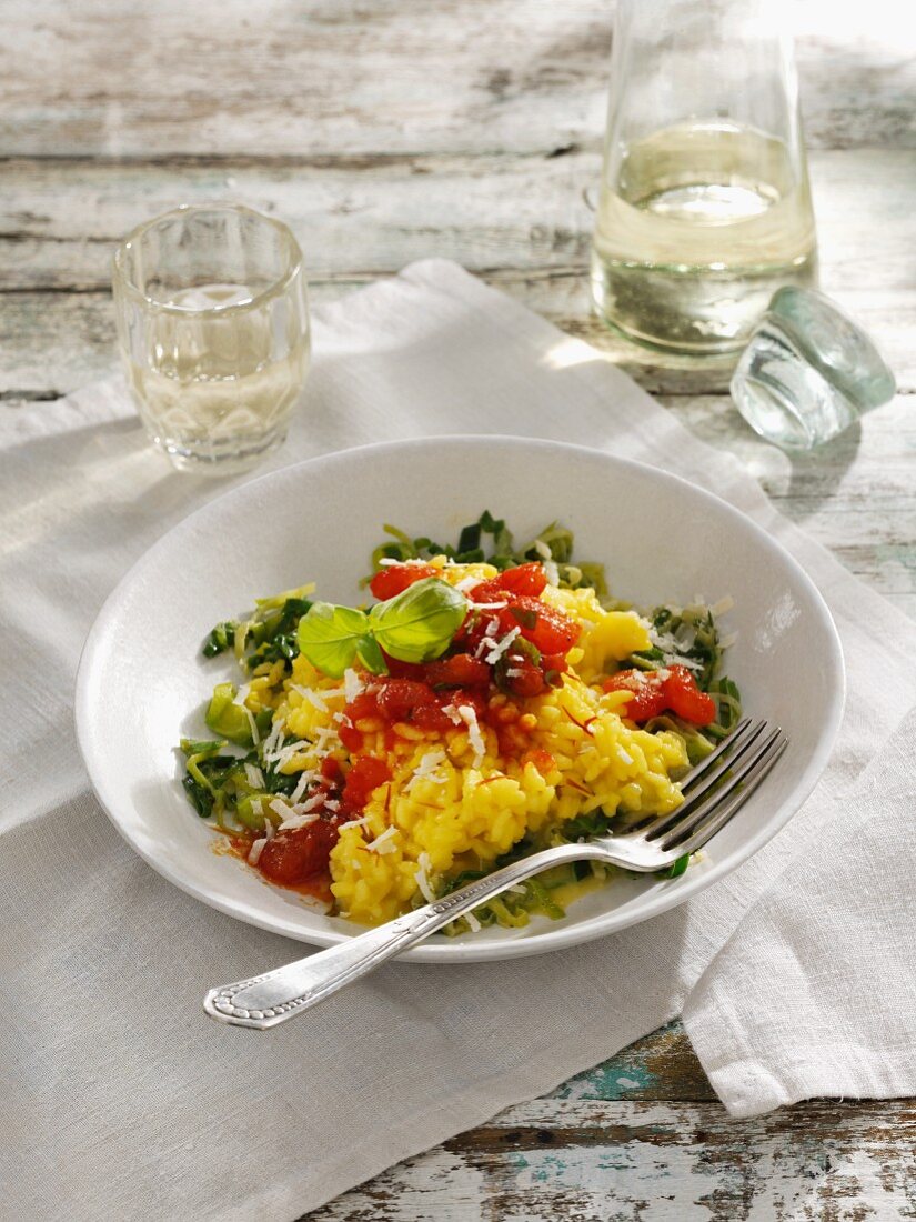 Saffron risotto on a bed of leek with braised tomatoes