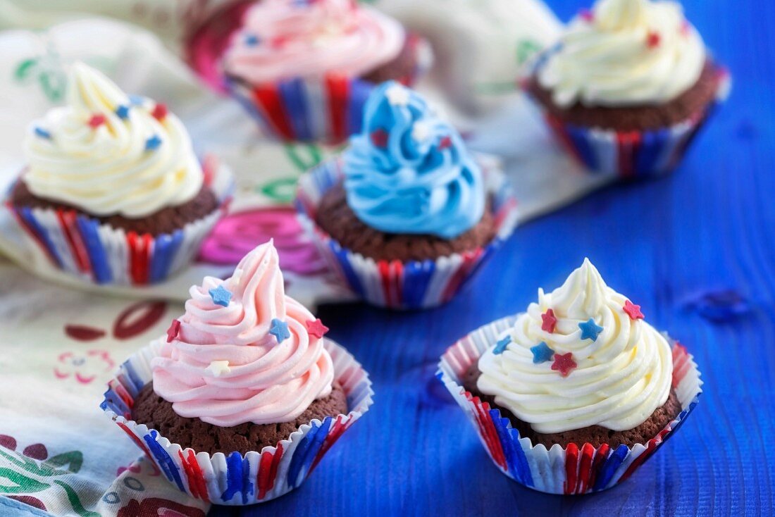 Chocolate cupcakes topped with coloured cream
