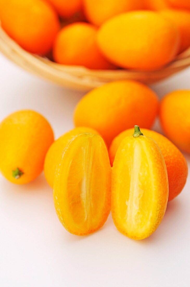 Mehrere Kumquats, ganz und halbiert