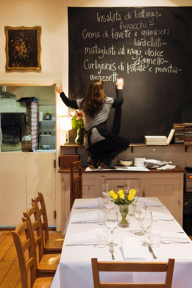 Young women writing a menu of the day