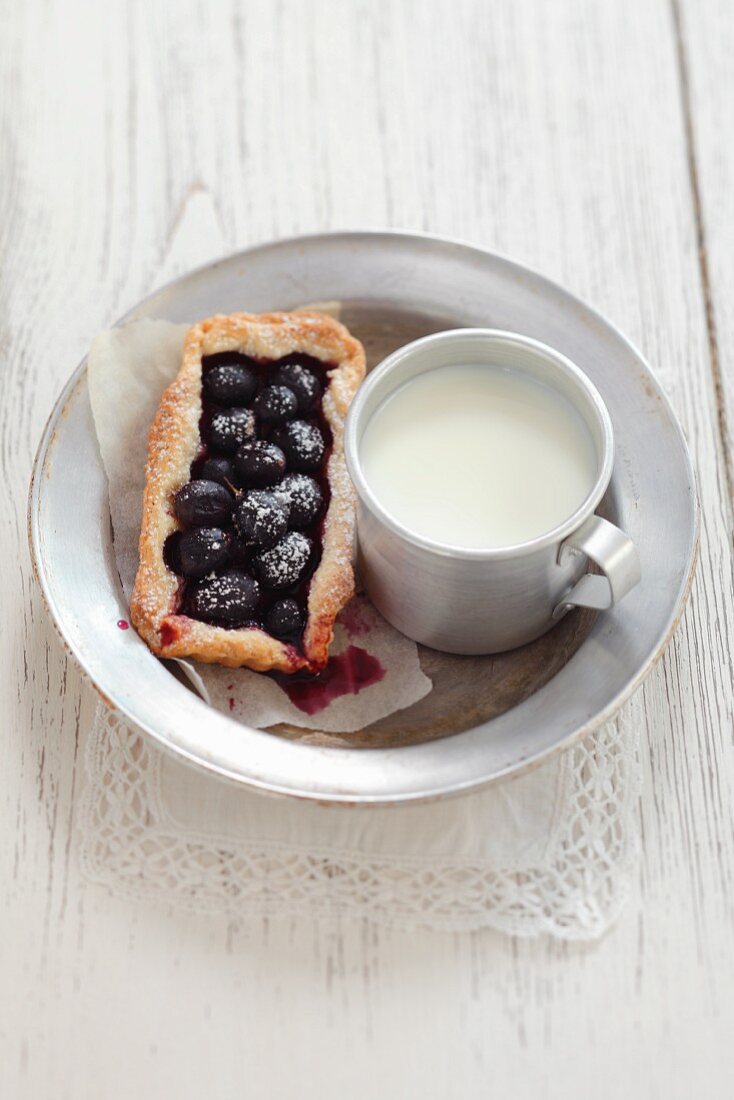 Grape tartlet and a mug of milk