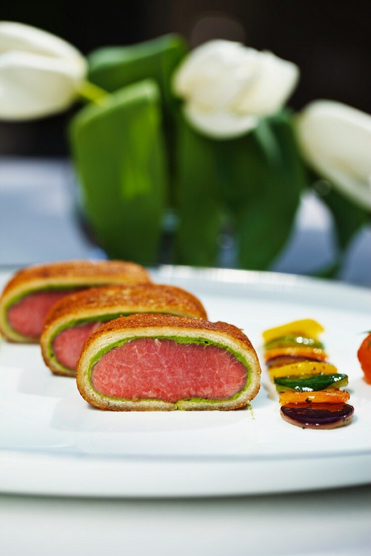 Saddle of lamb with a bread and ramson crust and a side of vegetables