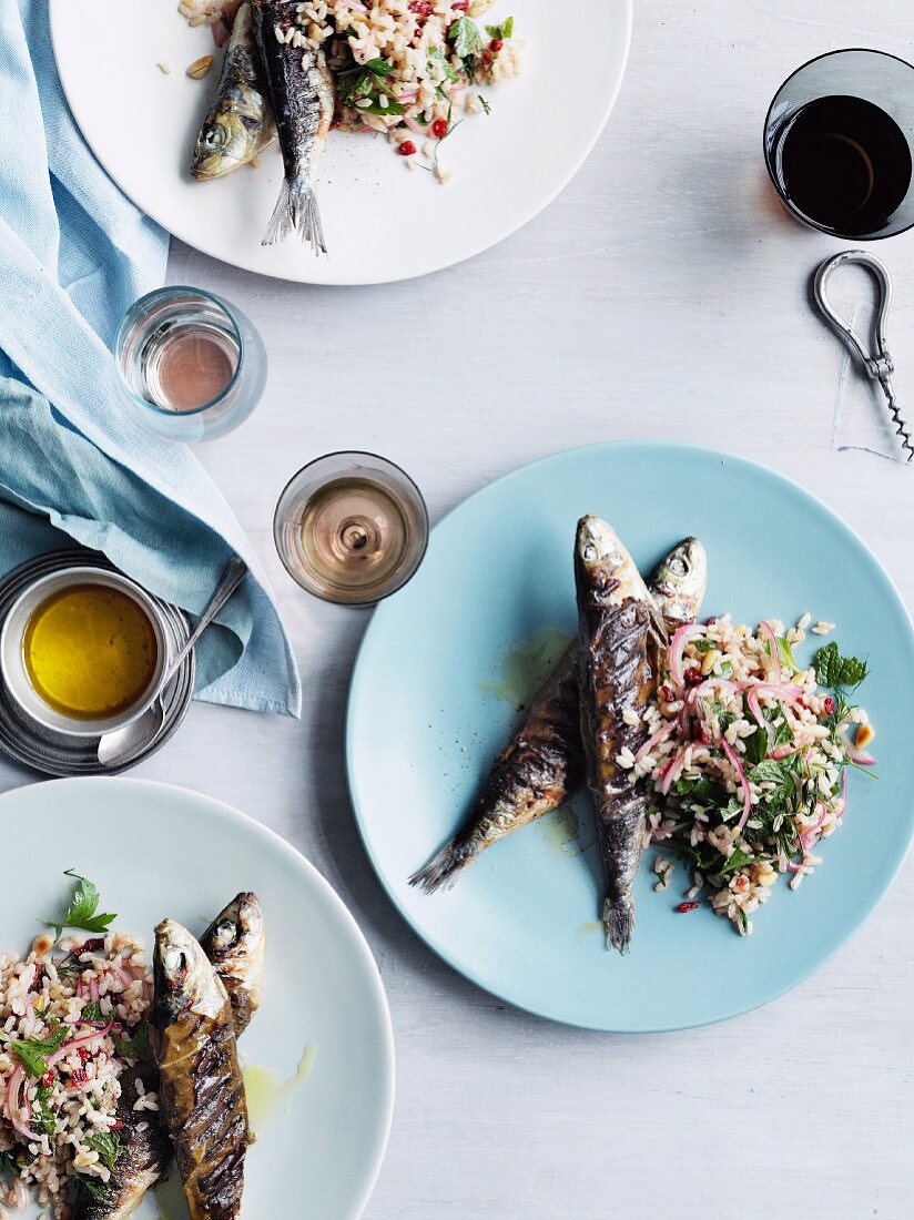 Grilled sardines in vine leaves with brown rice, pine nuts and barberries