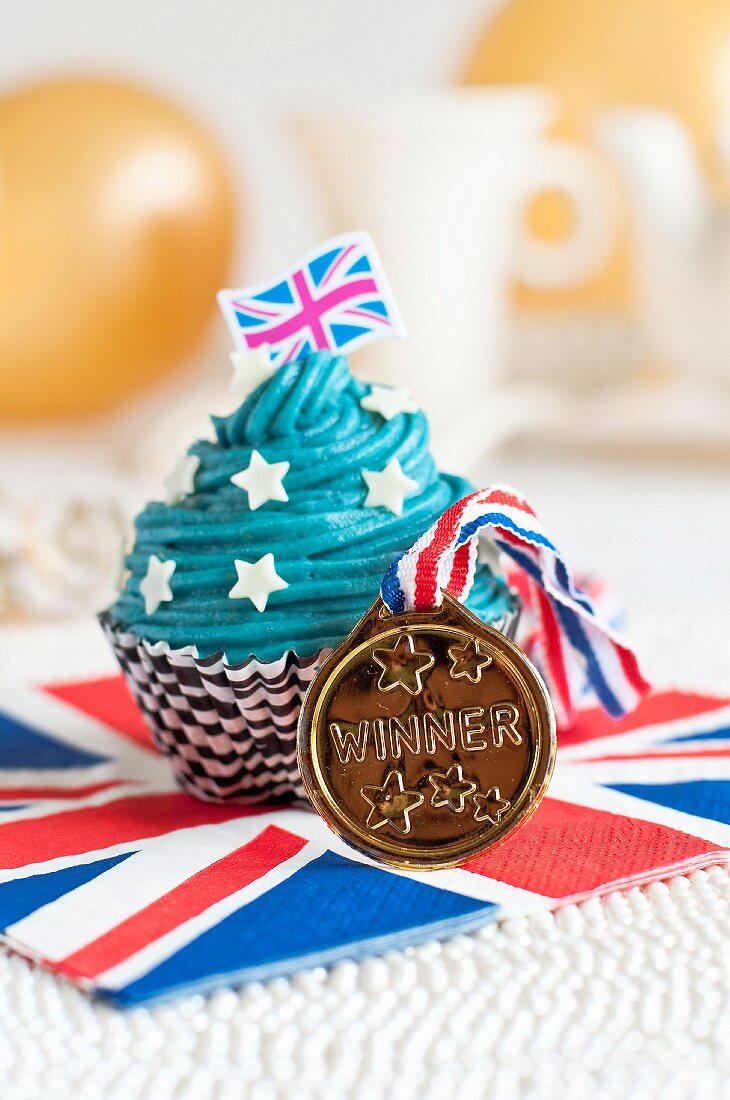 A cupcake decorated with a Union Jack and a medal