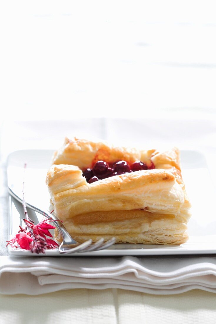 A puff pastry slice filled with marzipan and blueberries