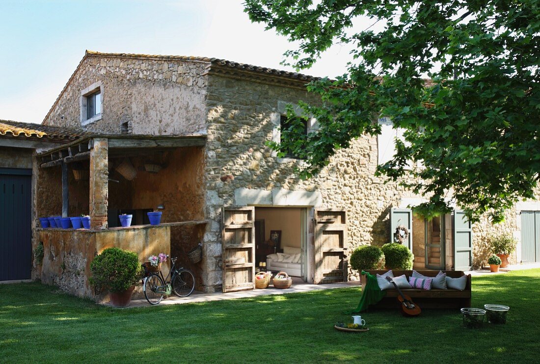 Rustic stone house with large lawn