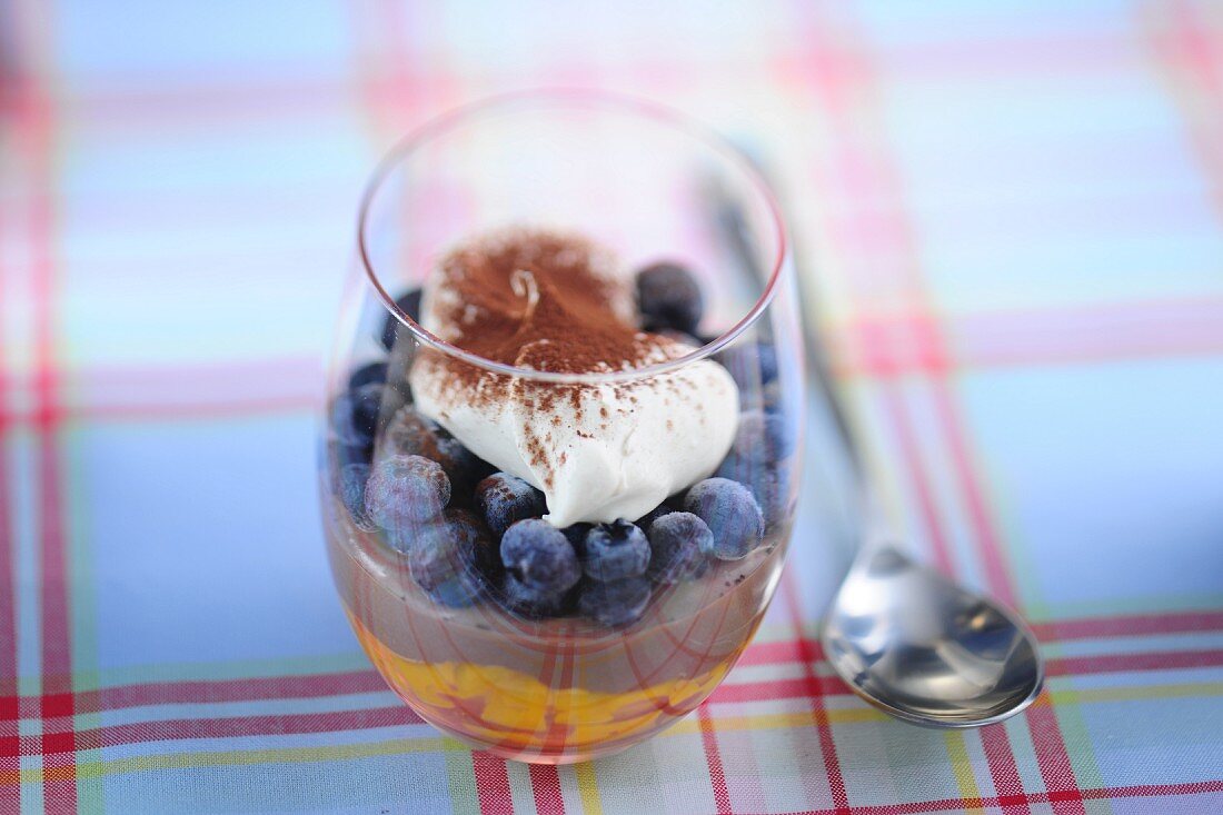 Chocolate cream with mango, blueberries and cream