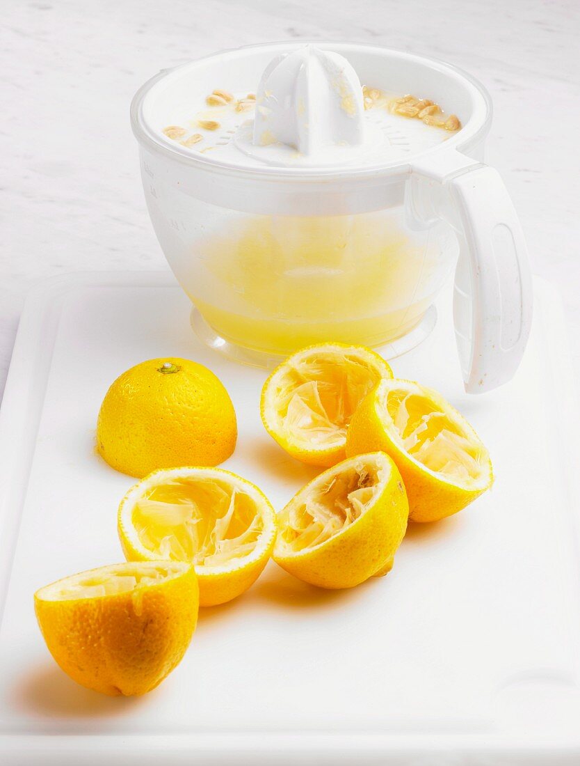 Juiced lemons and a lemon juicer