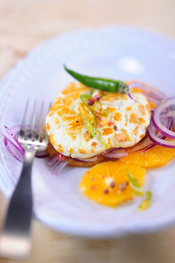 Goats cheese on an orange and onion salad