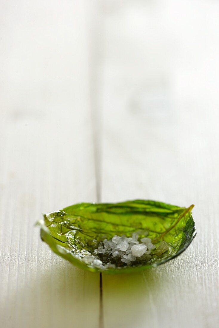 A candied basil leaf with salt