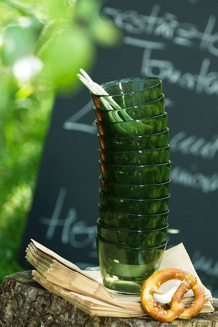 Stacked glasses and pretzel in garden