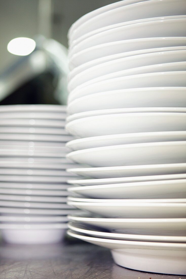A stack of plates in a commercial kitchen