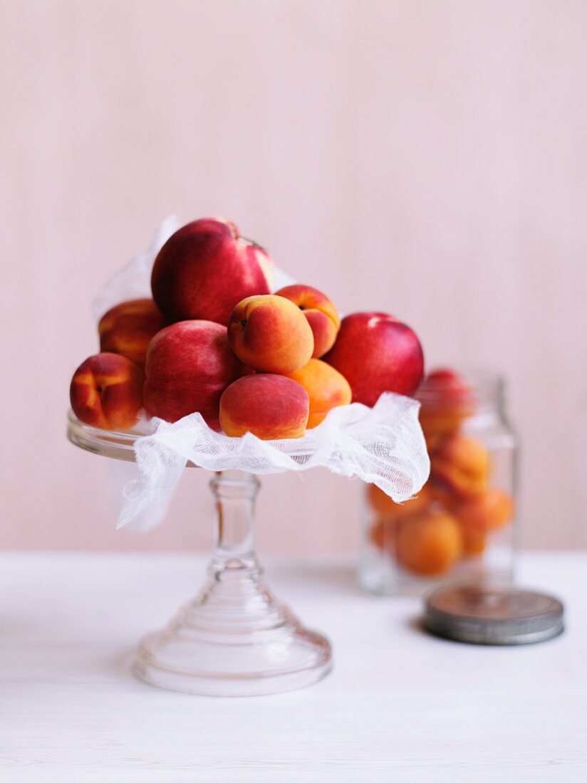 Nectarines and peaches on a cake stand