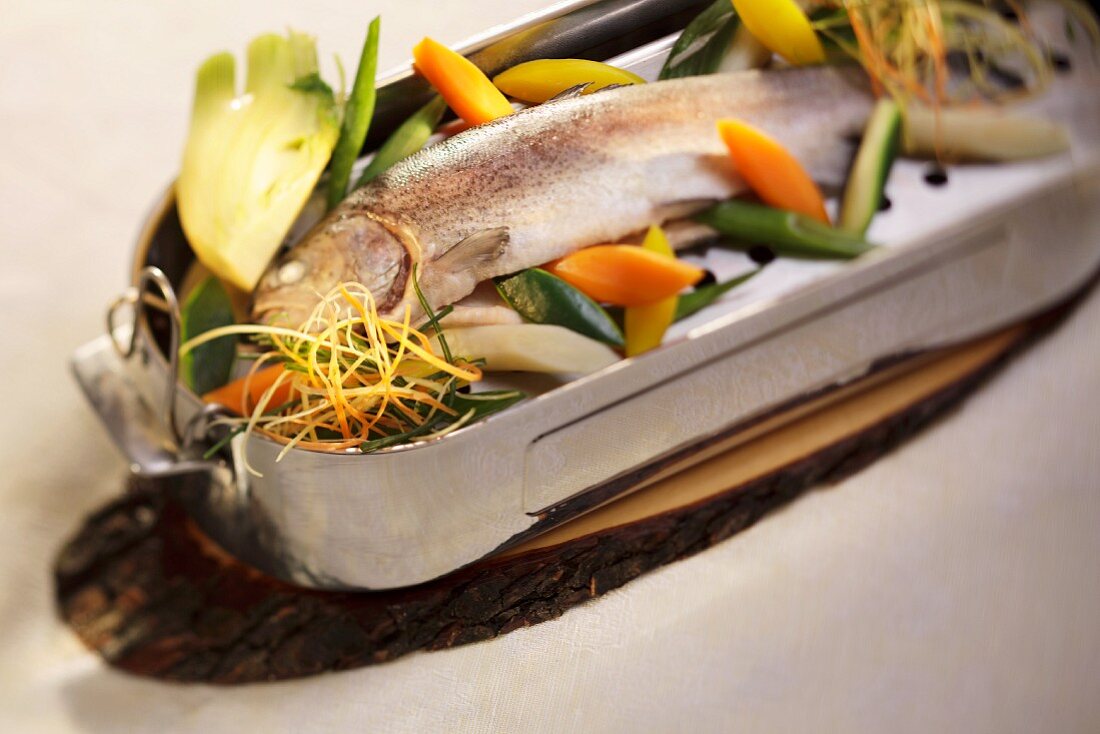 Poached trout with vegetables