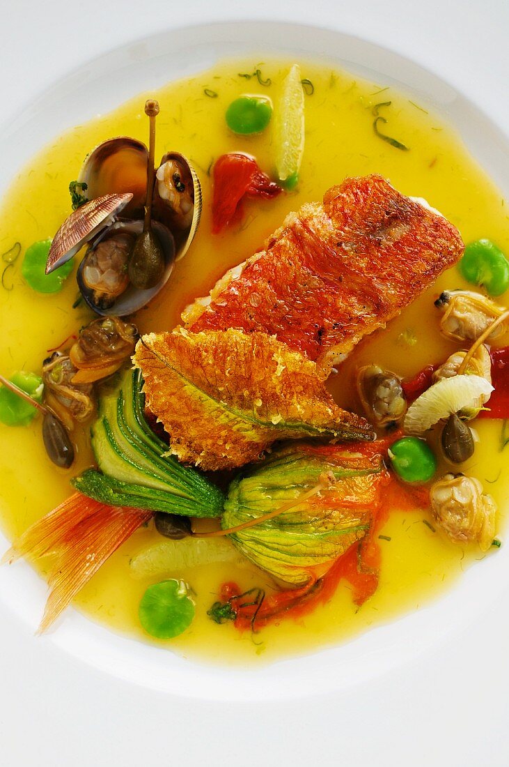 Stuffed red mullet in a caper and lime broth with courgette flowers