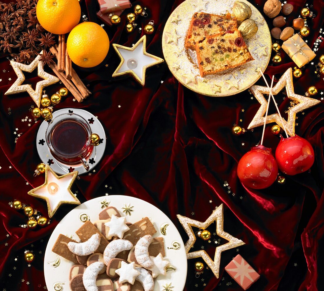 Christmas cakes and biscuits, punch and toffee apples forming a frame