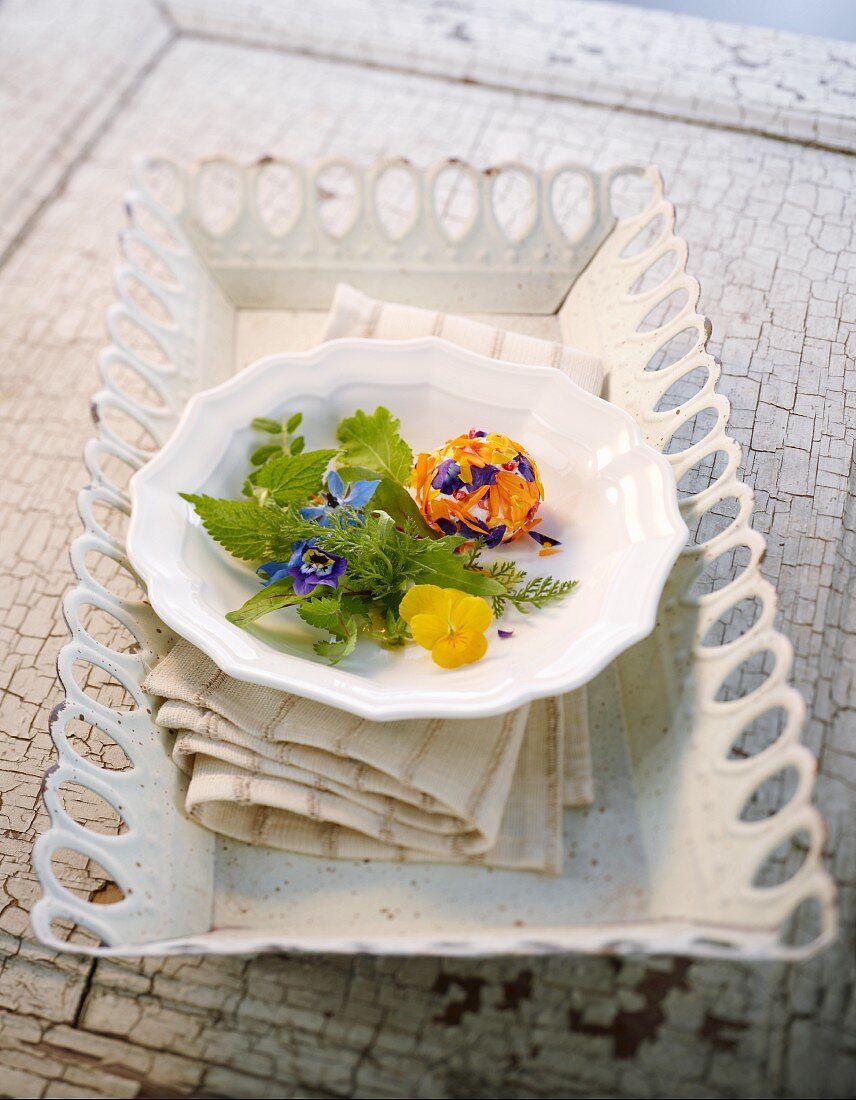 Wild herb salad with edible flowers and cream cheese balls