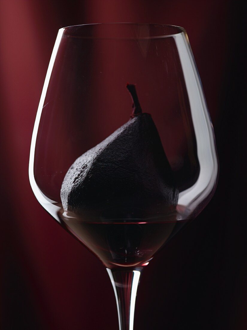 A red wine pear in a wine glass