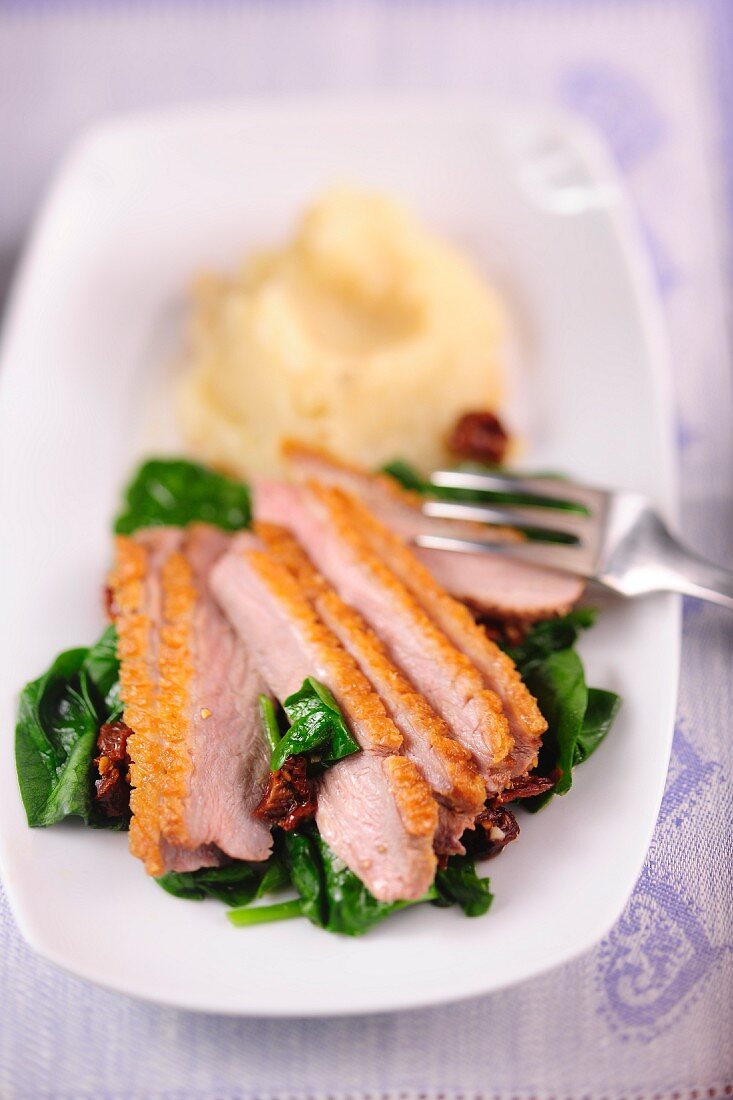 Barbarie duck breast with spinach, dried tomatoes and celery purée