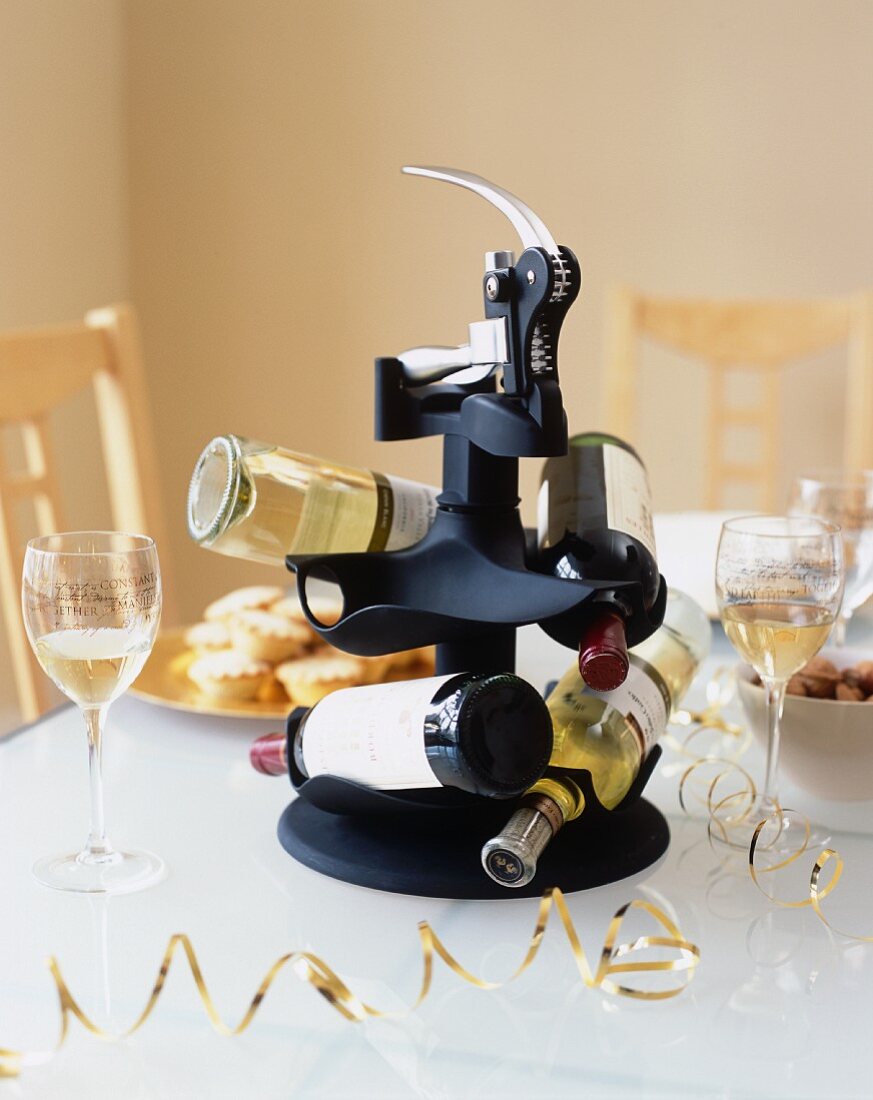 A wine bottle holder on a table laid for Christmas dinner