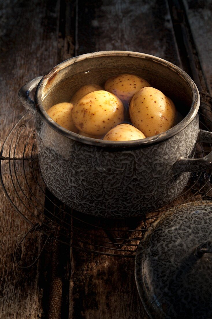 Unpeeled potatoes in a pot of water
