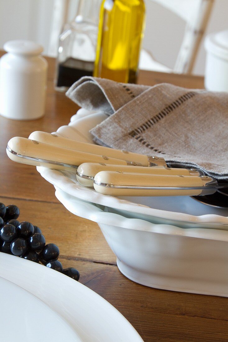 White plates, cutlery and a linen napkin