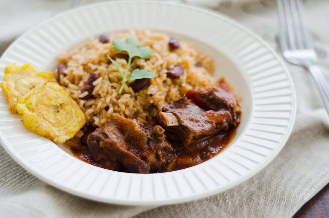 Goat ragout with beans and rice and tostones (Jamaica)