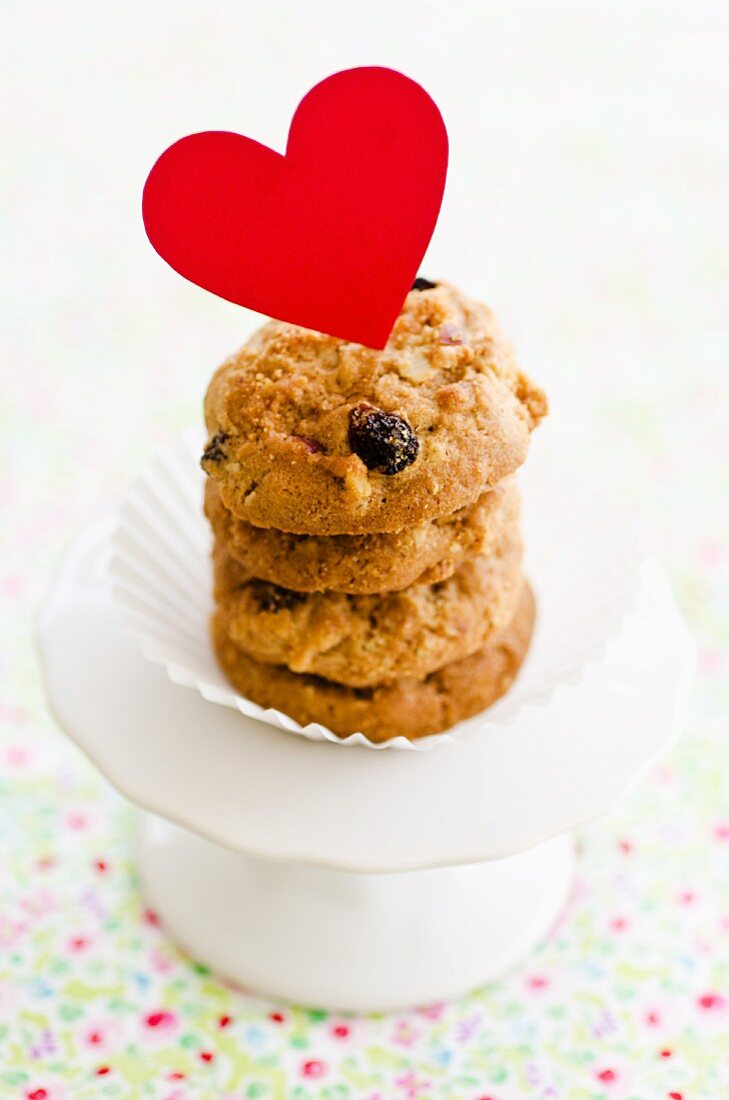 A stack of raisin biscuits decorated with a heart for Valentine's Day