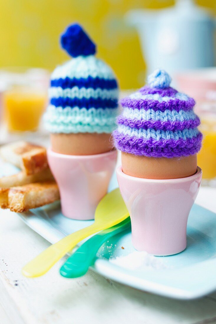 Boiled eggs with knitted egg cosies
