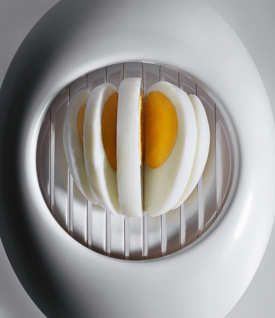 A hard-boiled egg in an egg cutter (close-up)