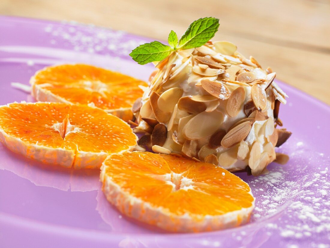 Ricotta parfait with almonds and orange slices