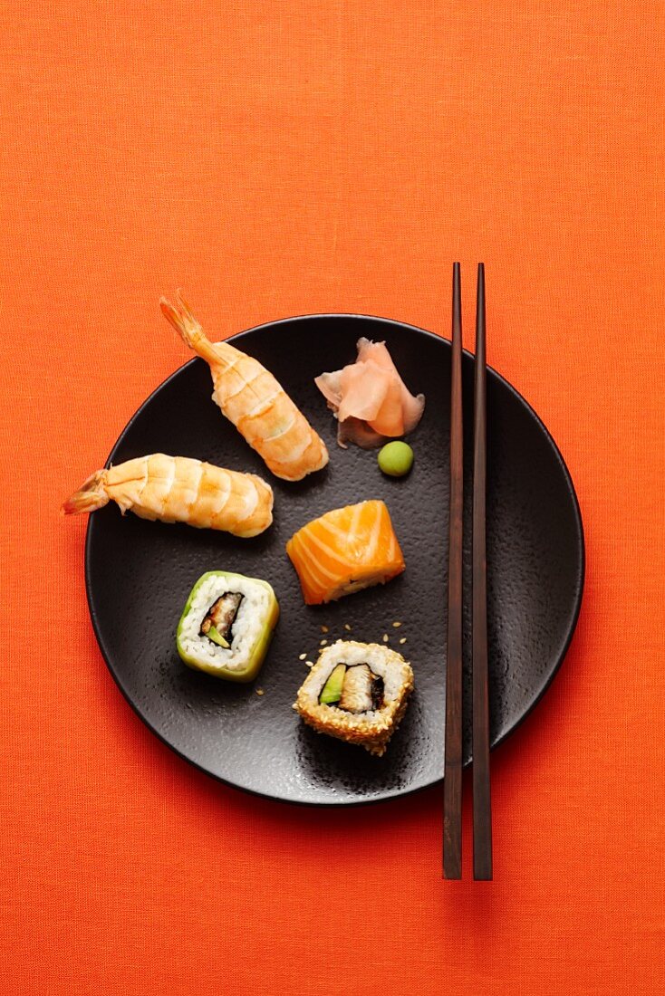 A sushi plate with wasabi and ginger