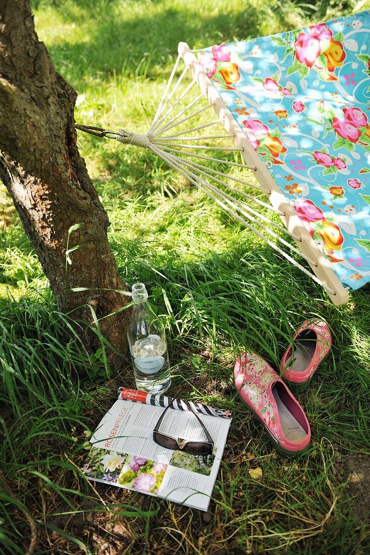 Taking a break in the garden - newspaper and drink under shady tree