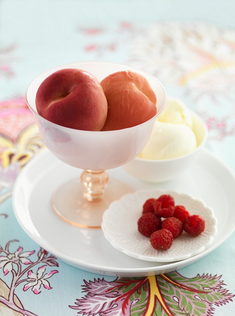 Peaches poached in rose water with raspberry and vanilla ice cream