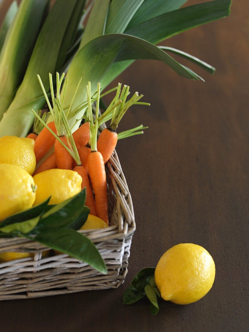Lemons, carrots and leek in a basket