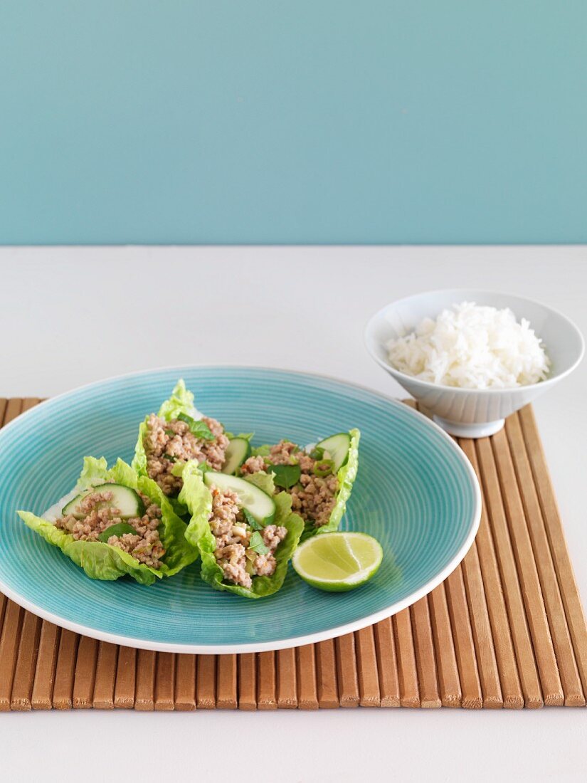Spicy minced pork in lettuce leaves with rice (Thailand)