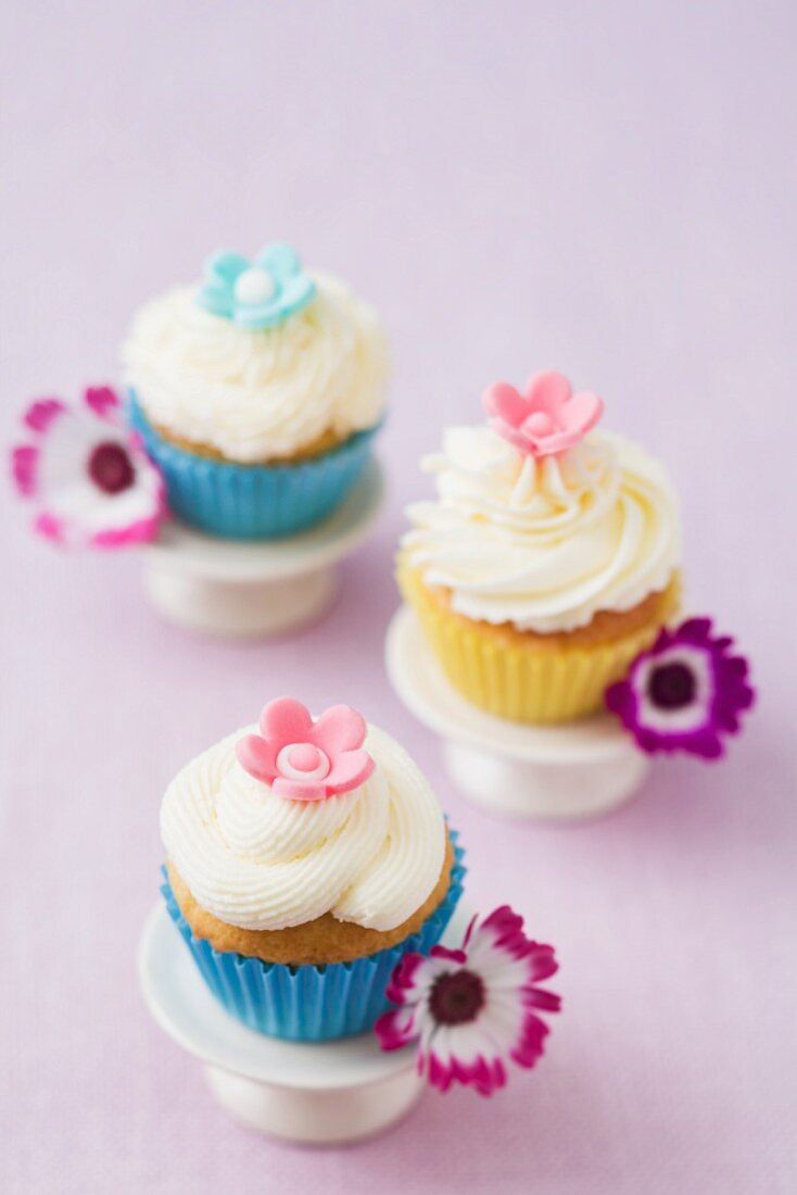 Three cupcakes decorated with flowers