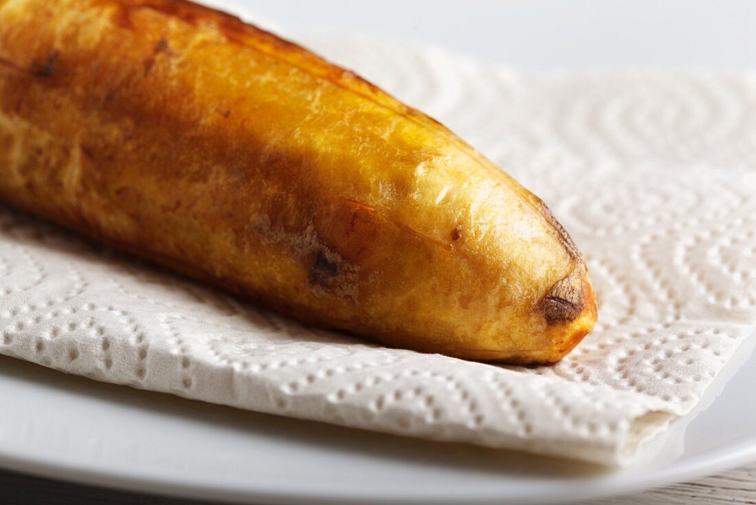 A fried plantain on kitchen paper