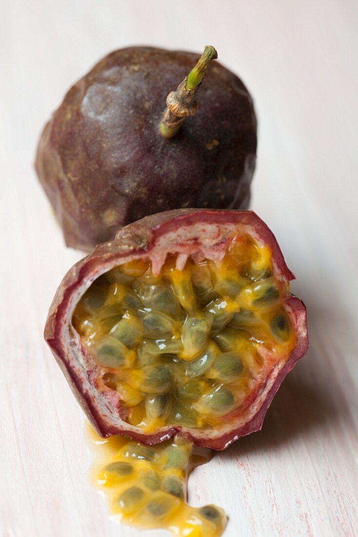 A whole and a halved passion fruit