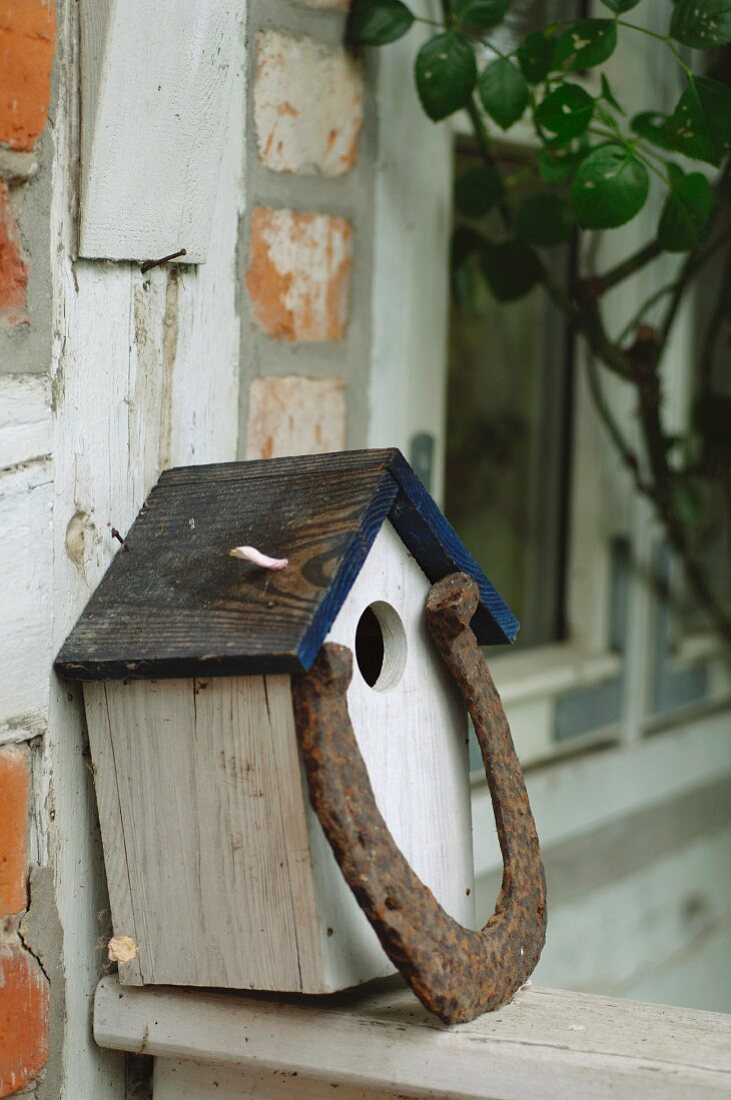 Birdhouse at timber-framed house