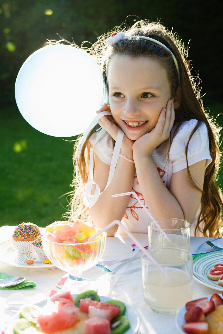 Girl smiling happily at birthday party