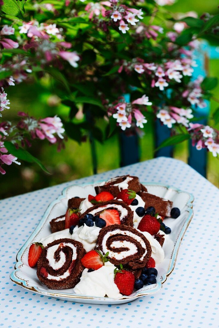 Chocolate Swiss roll with cream and berries