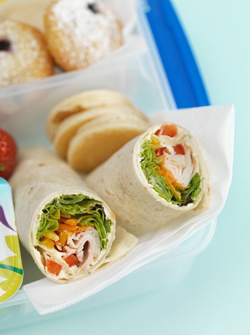 Chicken wraps in a lunchbox (close-up)