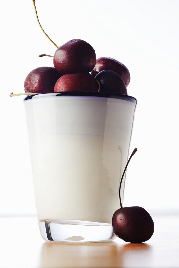 Black Cherries in a Cup; One Next to a Cup
