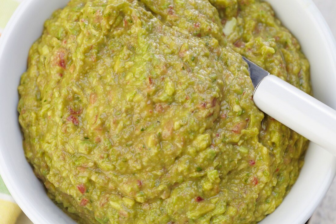 Bowl of Guacamole with a Spoon;From Above