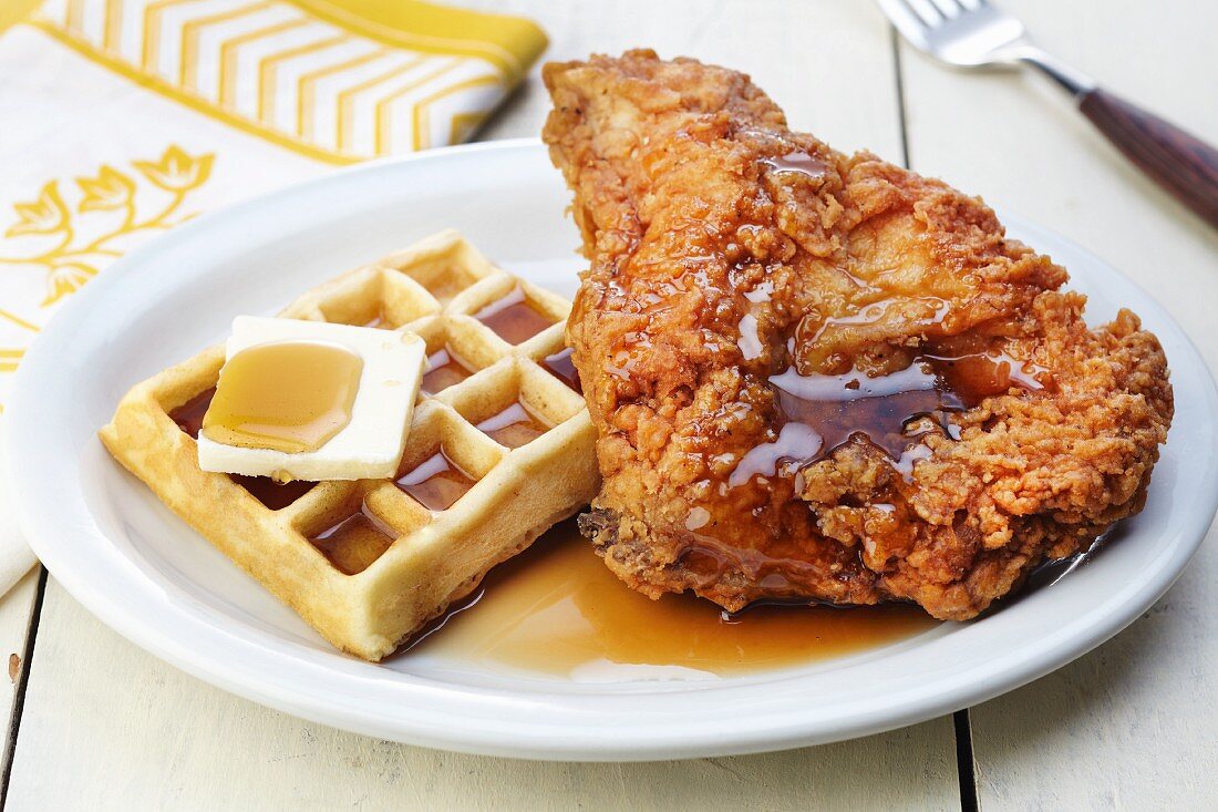 A Waffle and Fried Chicken with Maple Syrup and Butter