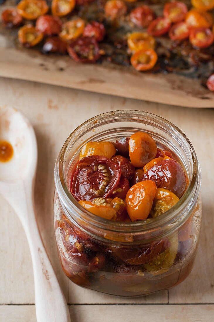Slow Roasted Cherry Tomatoes in a Glass Jar; Sheet of Roasted Cherry Tomatoes